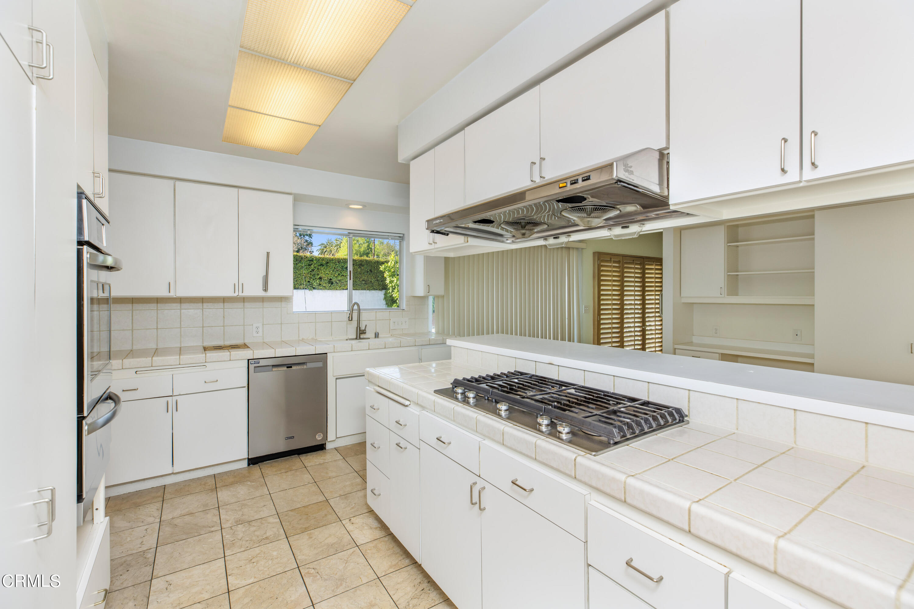 911 Arden Road Pasadena, CA 91106 - Photo 9 of 19 a kitchen with stainless steel appliances granite countertop a sink stove and cabinets