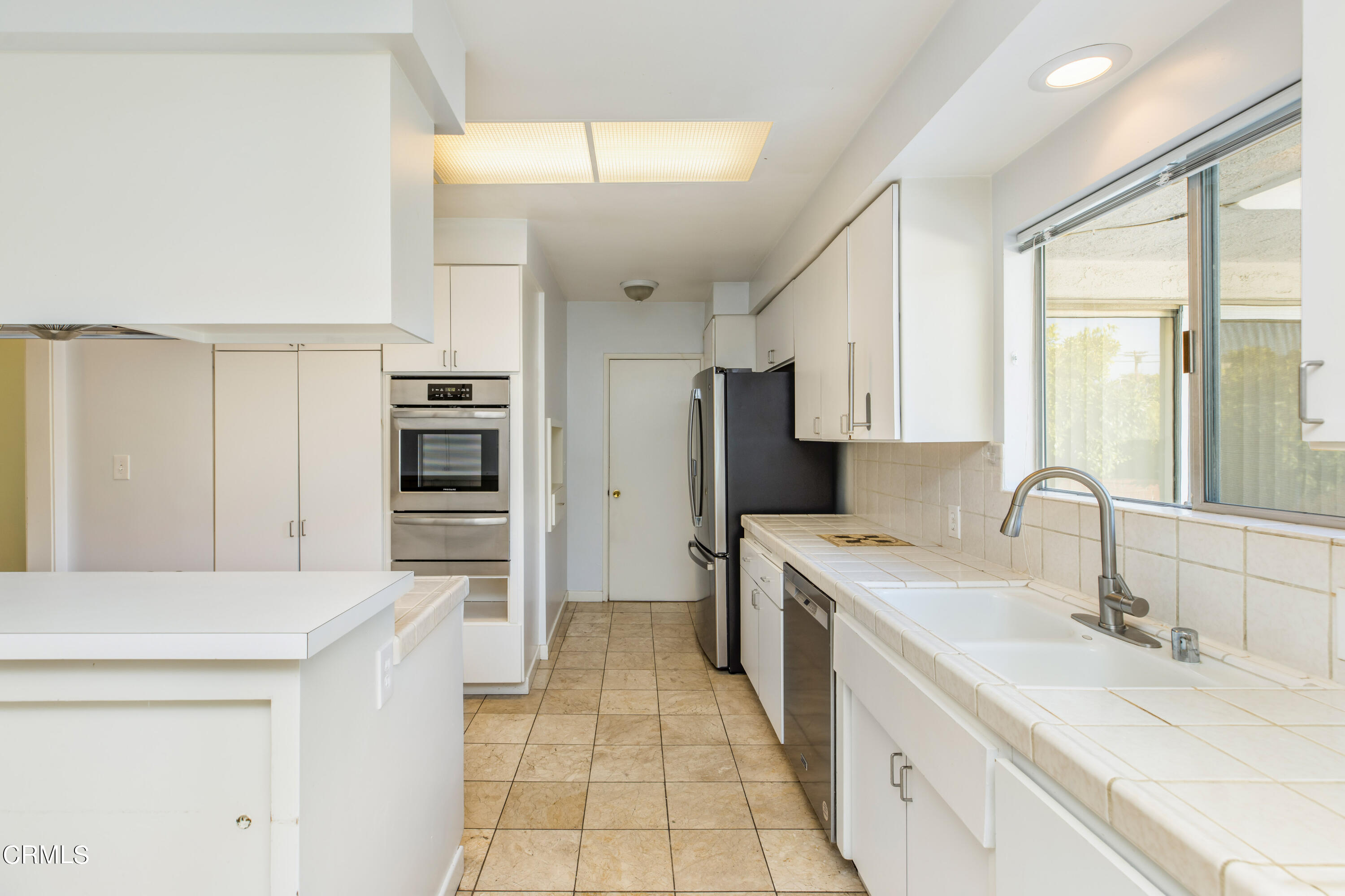 911 Arden Road Pasadena, CA 91106 - Photo 10 of 19 a kitchen with a sink a stove and refrigerator