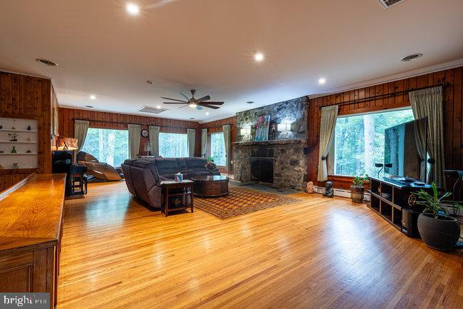 10246 Golf Course Road Fayetteville, PA 17222 - Photo 12 of 62 a living room with furniture a large window and a fireplace