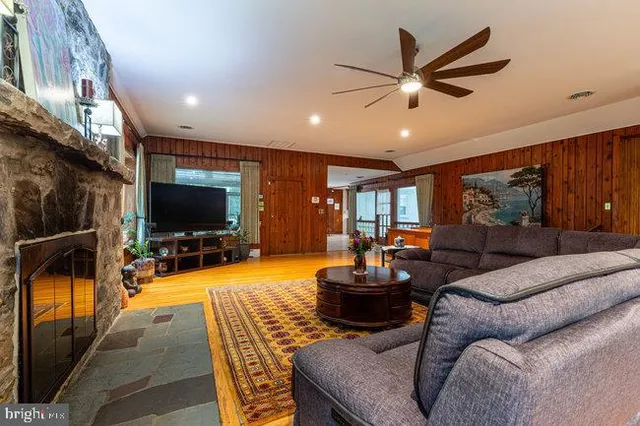 a living room with furniture a wooden floor and a window