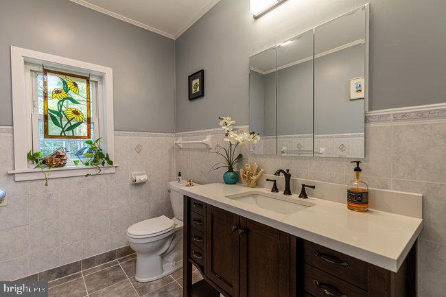 10246 Golf Course Road Fayetteville, PA 17222 - Photo 21 of 62 a bathroom with a sink a toilet and mirror