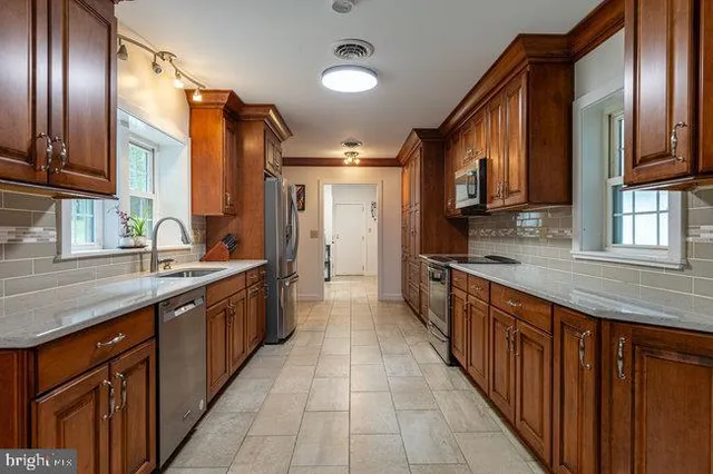 a dining room with furniture a refrigerator a table and chairs