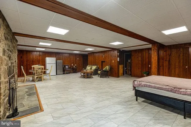 a living room with patio furniture and a rug