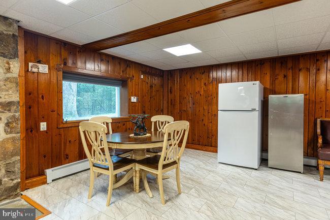 10246 Golf Course Road Fayetteville, PA 17222 - Photo 41 of 62 a dining room with furniture a refrigerator a table and chairs