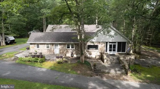 an aerial view of a house with a yard and garden