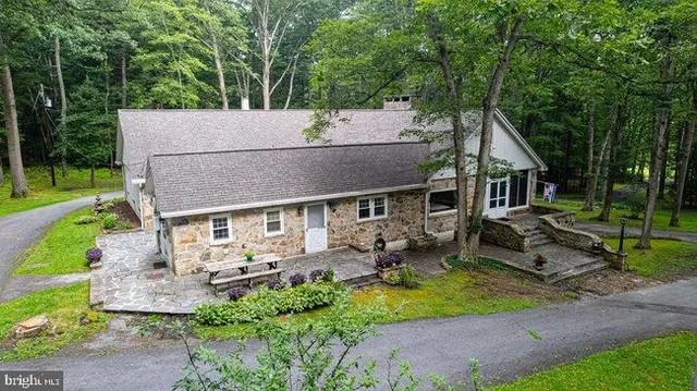 an aerial view of a house with a yard