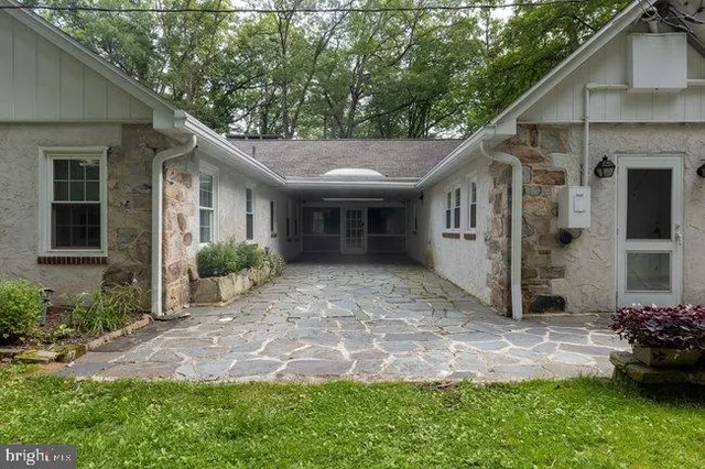 a view of a house with yard and a garden