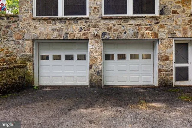 a living room with furniture a large window and a fireplace