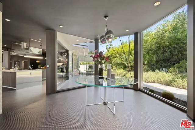 a large white kitchen with a large window