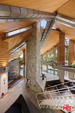 a bedroom with furniture and a large window