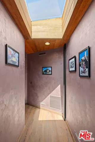 a view of walk in closet with wooden floor