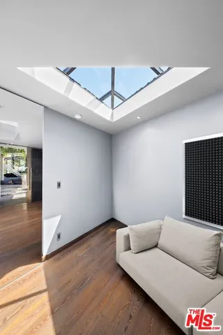 a dining room with furniture and a large window
