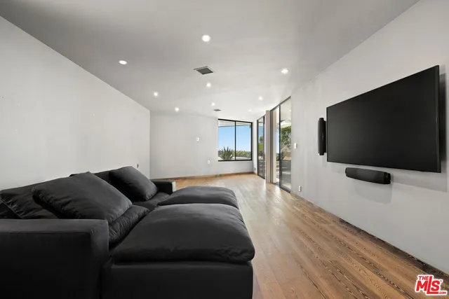 a living room with furniture and a floor to ceiling window