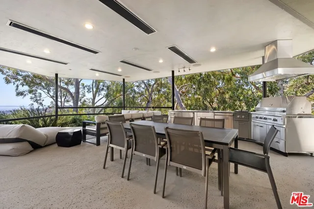 a view of a balcony with wooden floor and iron stairs