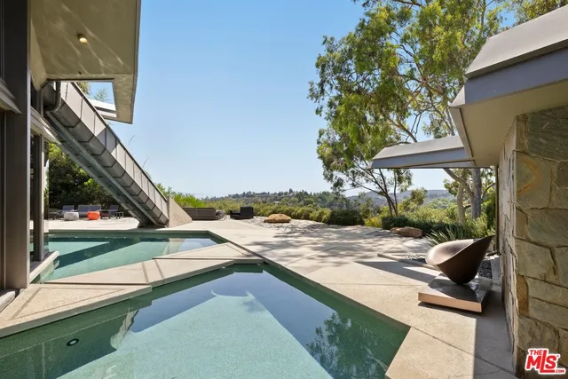 a aerial view of a house with a big yard and large trees