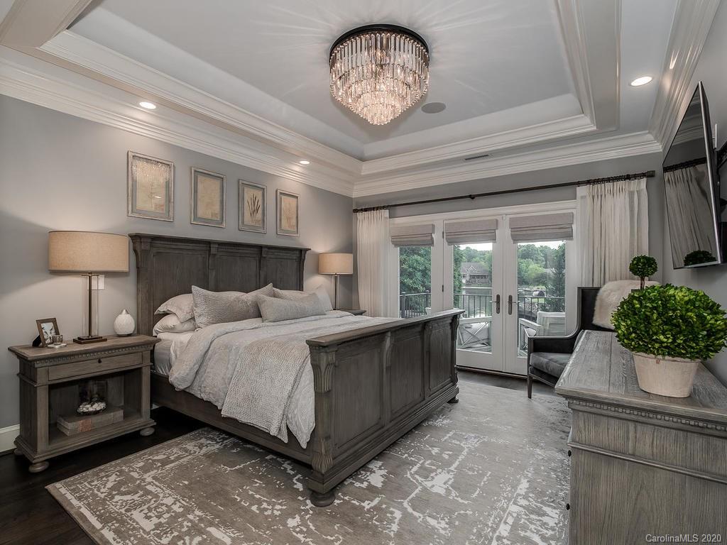 19506 Mary Ardrey Circle Cornelius, NC 28031 - Photo 12 of 36 a bed room with a bed and a chandelier