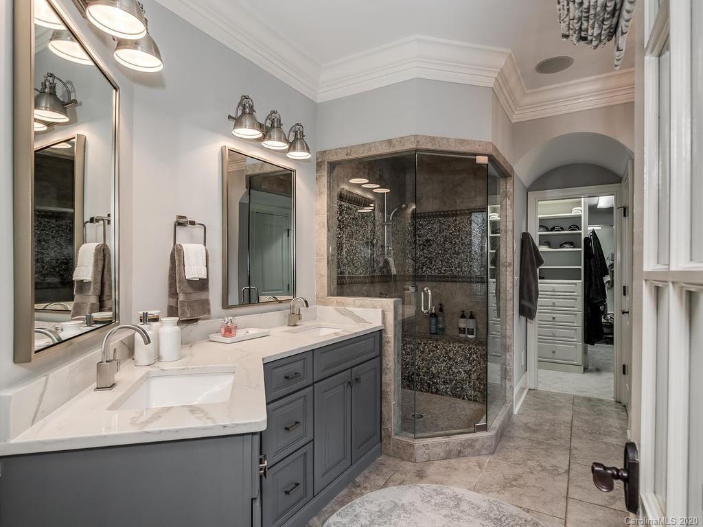 19506 Mary Ardrey Circle Cornelius, NC 28031 - Photo 13 of 36 a bathroom with a sink a vanity a shower and a mirror