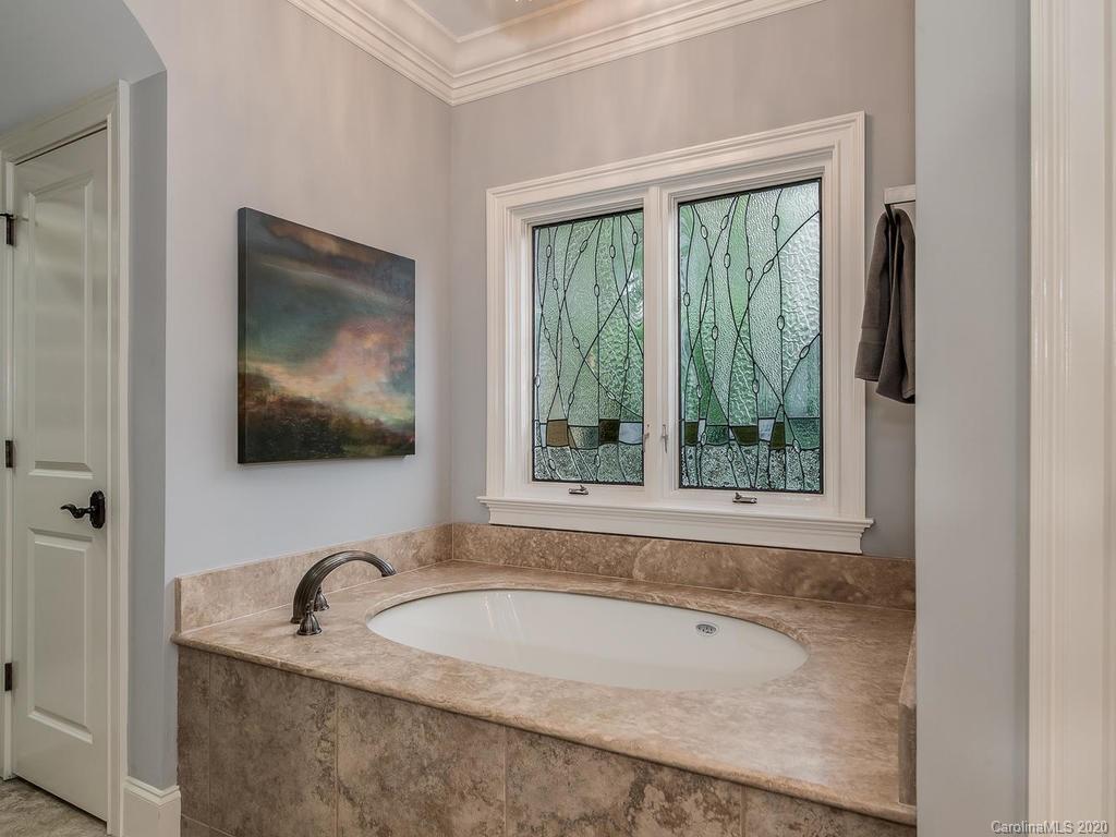 19506 Mary Ardrey Circle Cornelius, NC 28031 - Photo 14 of 36 a bathroom with a tub a sink and a large window