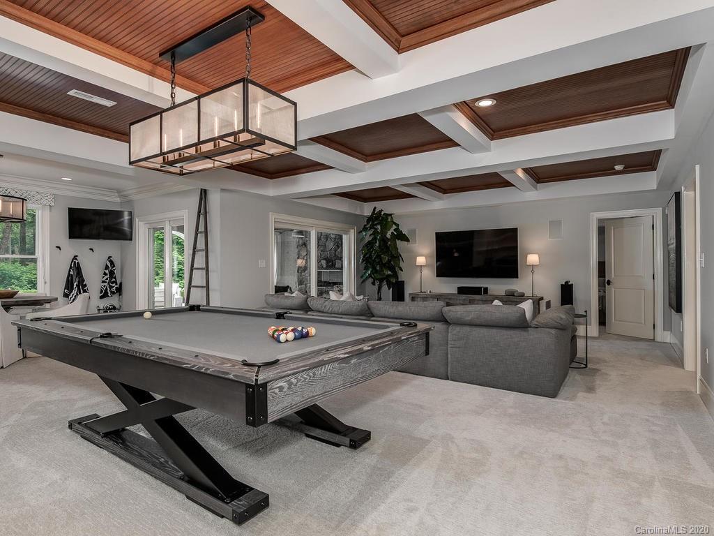 19506 Mary Ardrey Circle Cornelius, NC 28031 - Photo 18 of 36 a living room with furniture flat screen tv and a chandelier