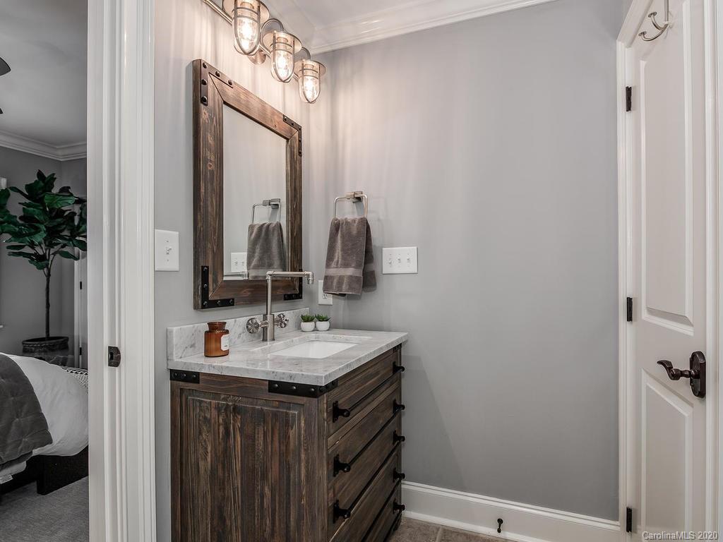 19506 Mary Ardrey Circle Cornelius, NC 28031 - Photo 21 of 36 a bathroom with a sink and a mirror