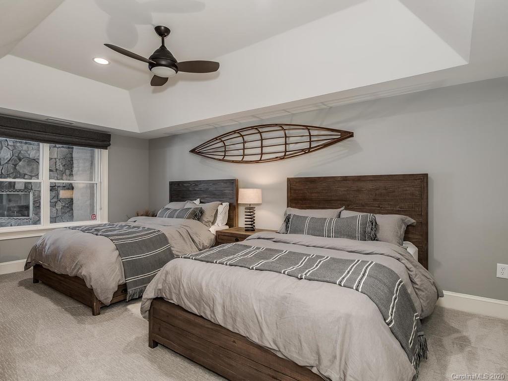 19506 Mary Ardrey Circle Cornelius, NC 28031 - Photo 22 of 36 a bedroom with two beds and a ceiling fan