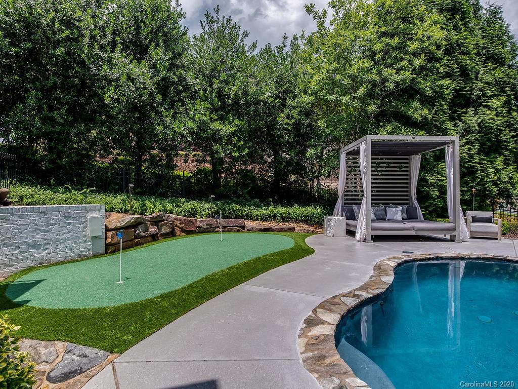 19506 Mary Ardrey Circle Cornelius, NC 28031 - Photo 25 of 36 a swimming pool with outdoor seating and garden