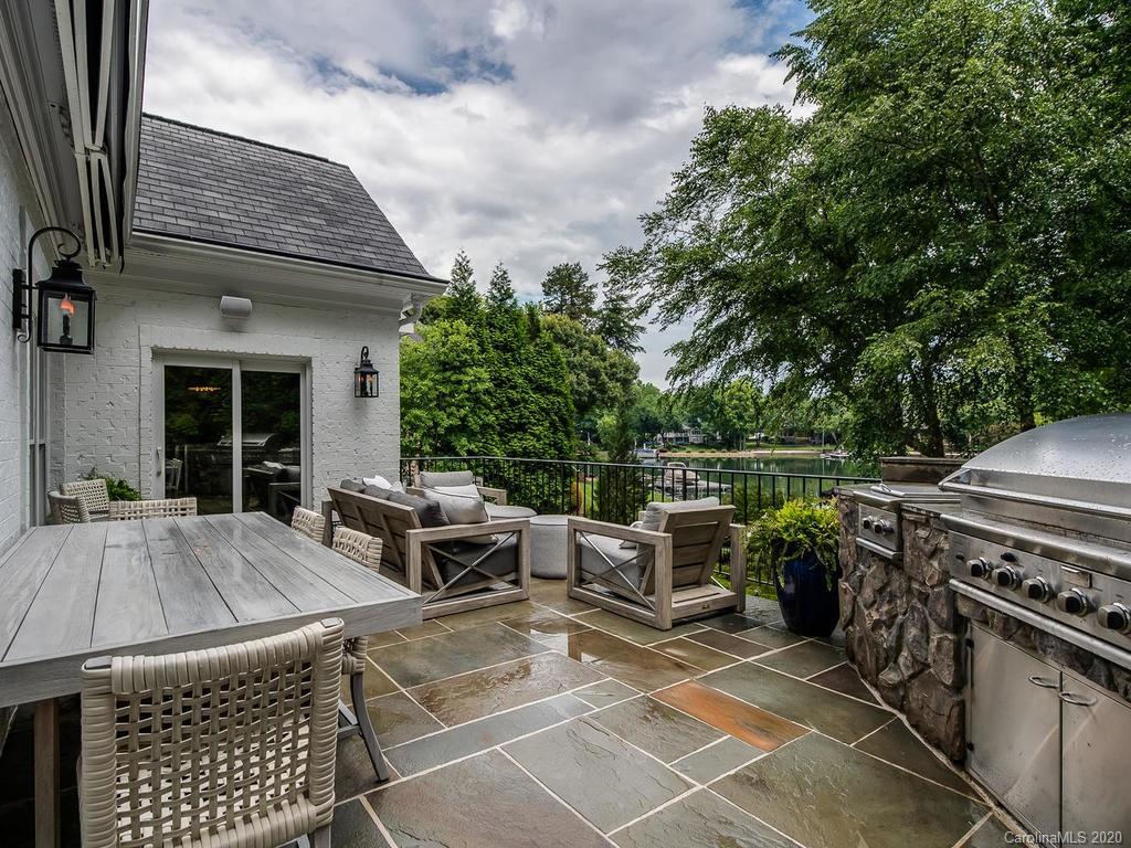 19506 Mary Ardrey Circle Cornelius, NC 28031 - Photo 29 of 36 a view of a patio with a dining table and chairs with wooden floor