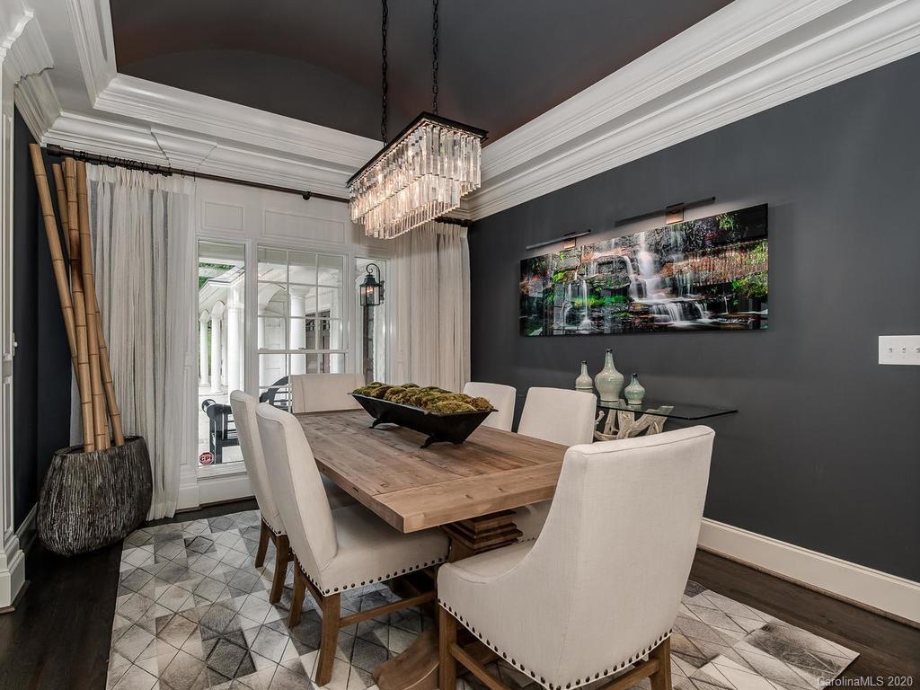 19506 Mary Ardrey Circle Cornelius, NC 28031 - Photo 4 of 36 a view of a dining room with furniture a chandelier and wooden floor