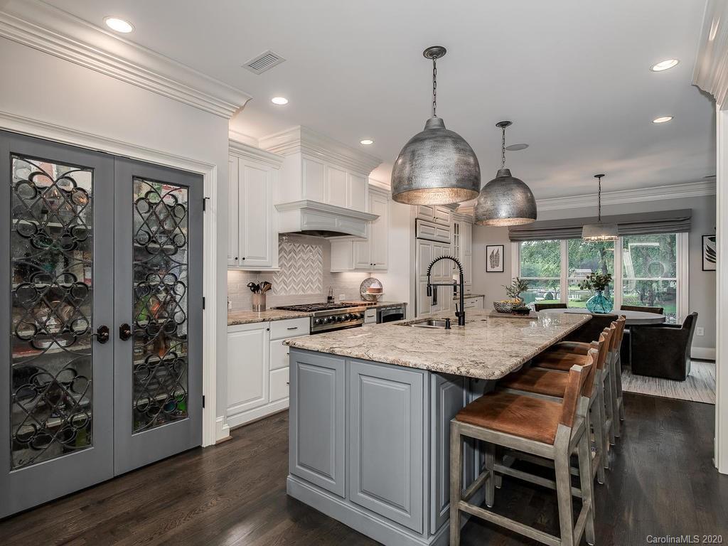 19506 Mary Ardrey Circle Cornelius, NC 28031 - Photo 6 of 36 a kitchen with stainless steel appliances granite countertop a sink a stove and a wooden floors