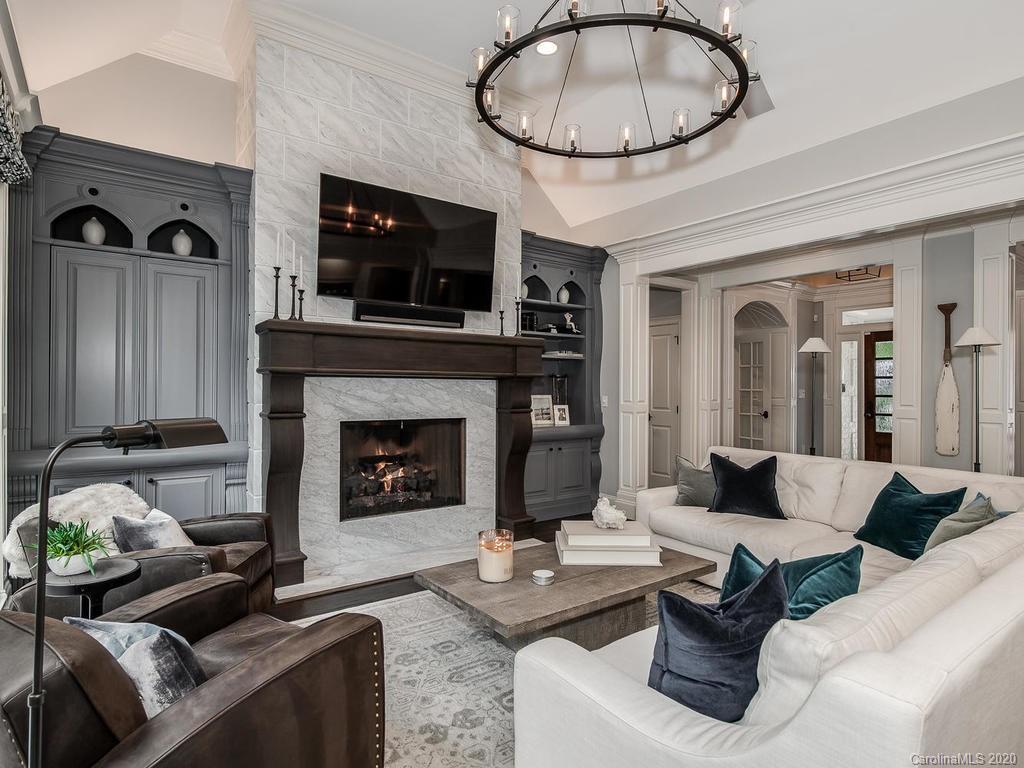 19506 Mary Ardrey Circle Cornelius, NC 28031 - Photo 8 of 36 a living room with furniture a flat screen tv and a fireplace