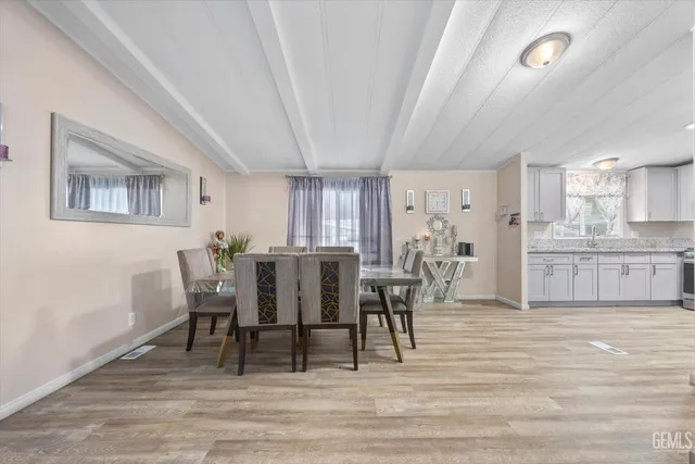 a view of a dining room with furniture and a wooden floor