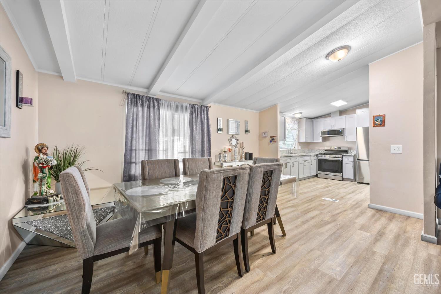 Undisclosed Address Delano, CA 93215 - Photo 14 of 43 a view of a dining room with furniture and a wooden floor