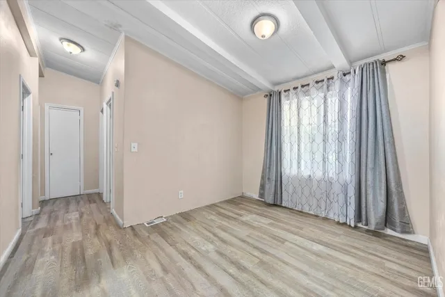 a view of wooden floor and windows in a room