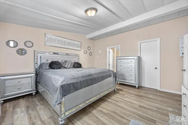 a large bedroom with a bed and a cabinets