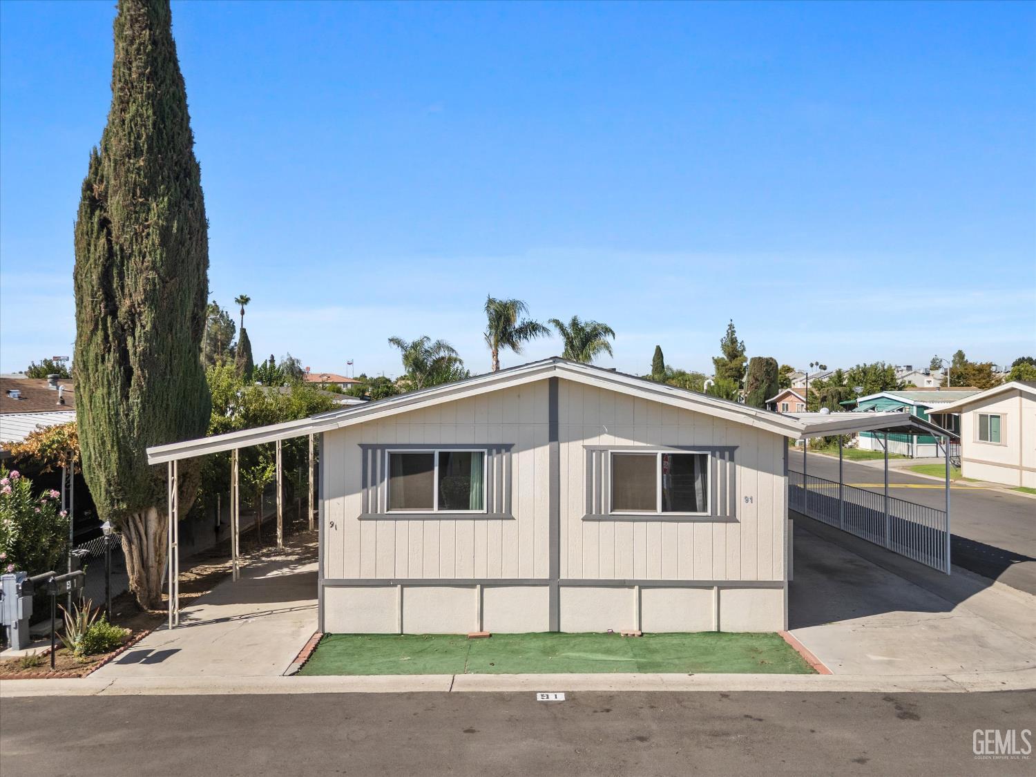 Undisclosed Address Delano, CA 93215 - Photo 3 of 43 a white house with a large window and yard