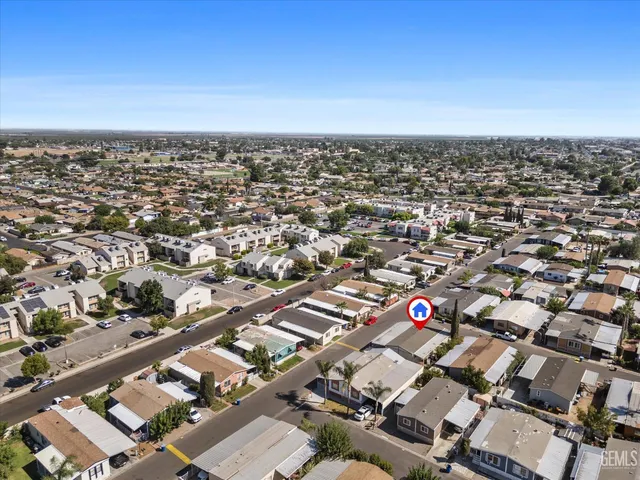an aerial view of residential houses with city view