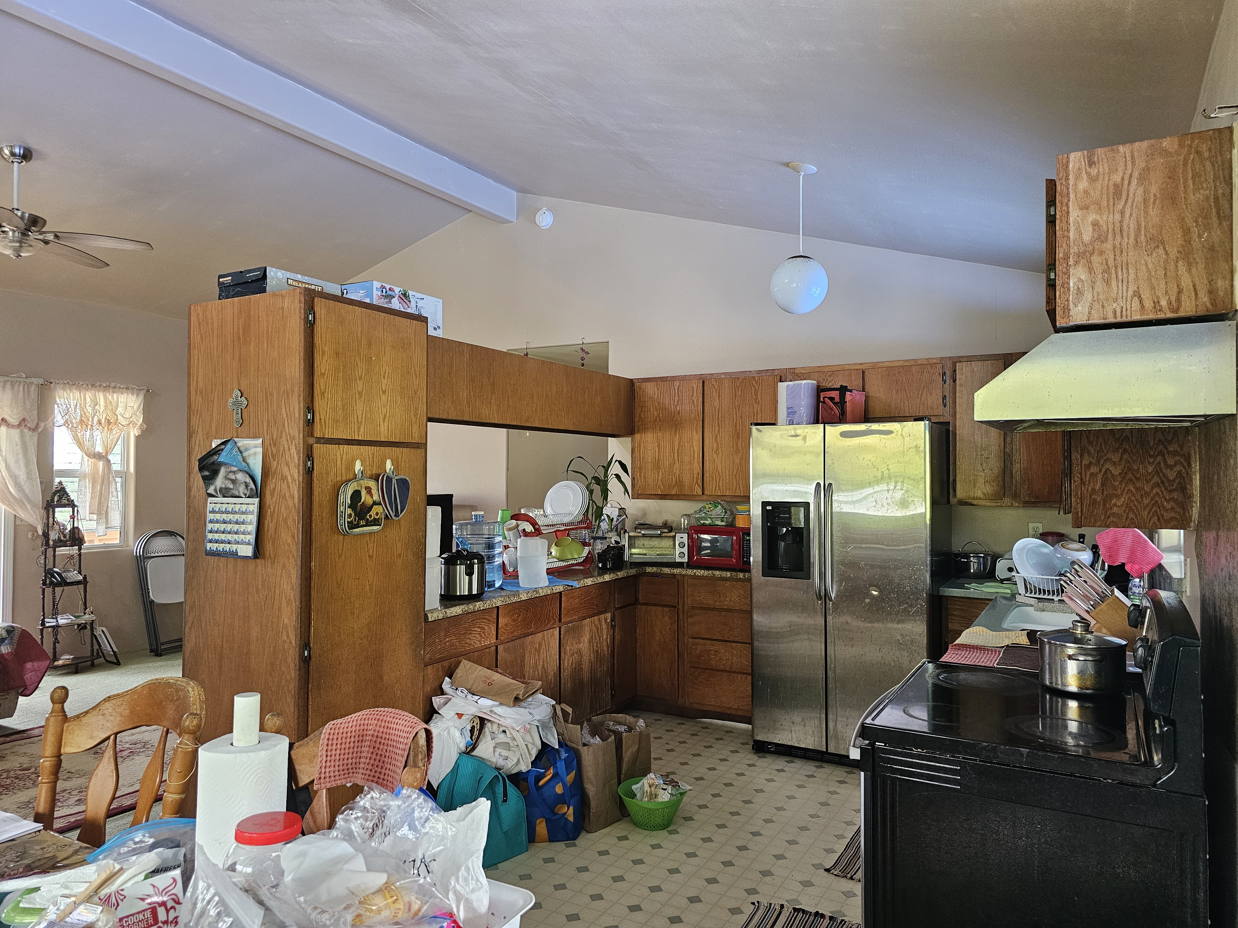 16-1754 Uhini Ana Road Pahoa, HI 96778 - Photo 16 of 21 a kitchen with stainless steel appliances kitchen island granite countertop a refrigerator a sink a stove and a refrigerator