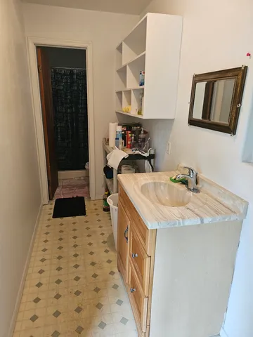 a kitchen with a sink a stove and cabinets