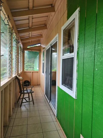a view of a porch with chairs and couches