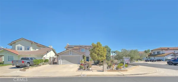 a front view of a house with outdoor seating