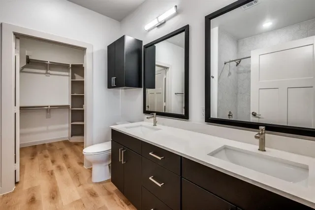 a bathroom with a double vanity sink and mirror