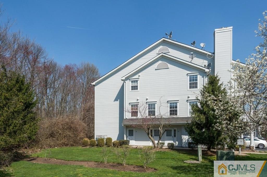 85 Prestwick Way, Unit 85 Edison, NJ 08820 - Photo 1 of 18 a front view of a house with a yard