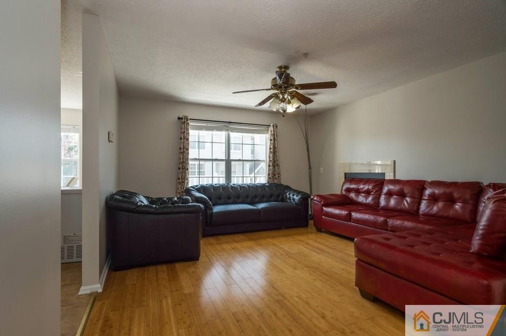 85 Prestwick Way, Unit 85 Edison, NJ 08820 - Photo 2 of 18 a living room with furniture and a window