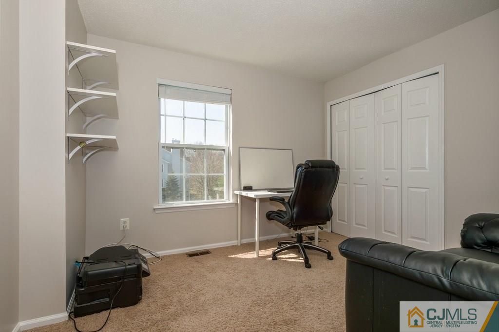 85 Prestwick Way, Unit 85 Edison, NJ 08820 - Photo 12 of 18 a view of a workspace with furniture and a window