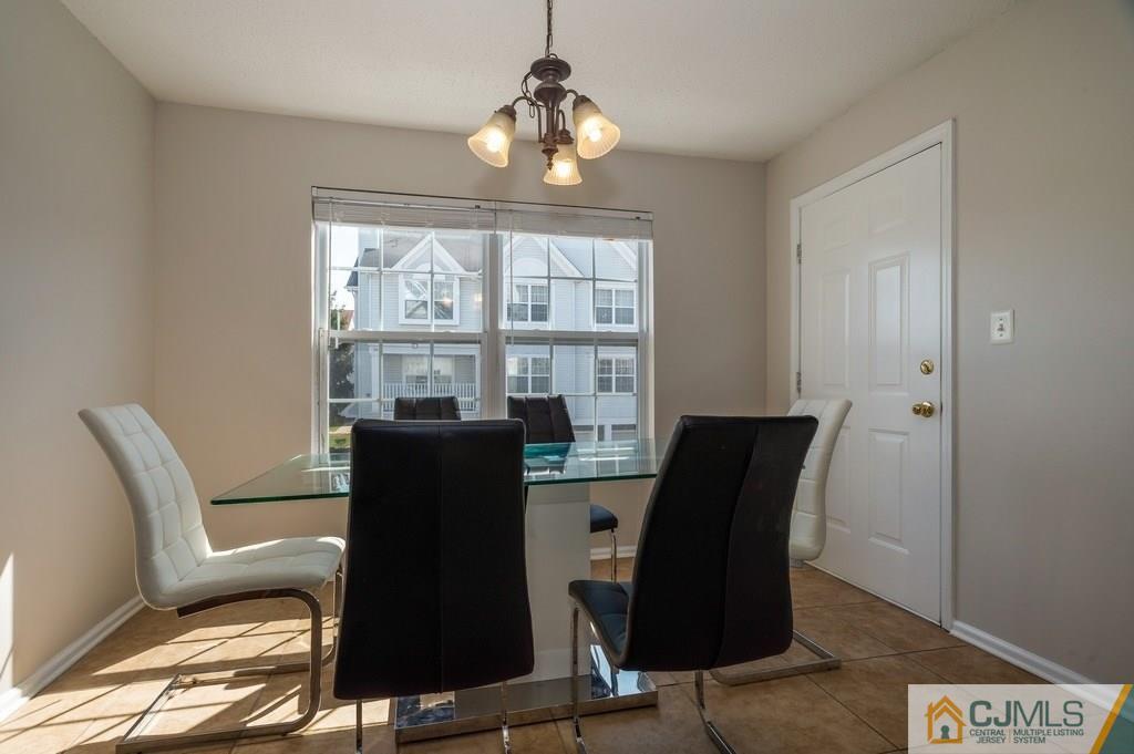 85 Prestwick Way, Unit 85 Edison, NJ 08820 - Photo 6 of 18 a view of a workspace with furniture and a window