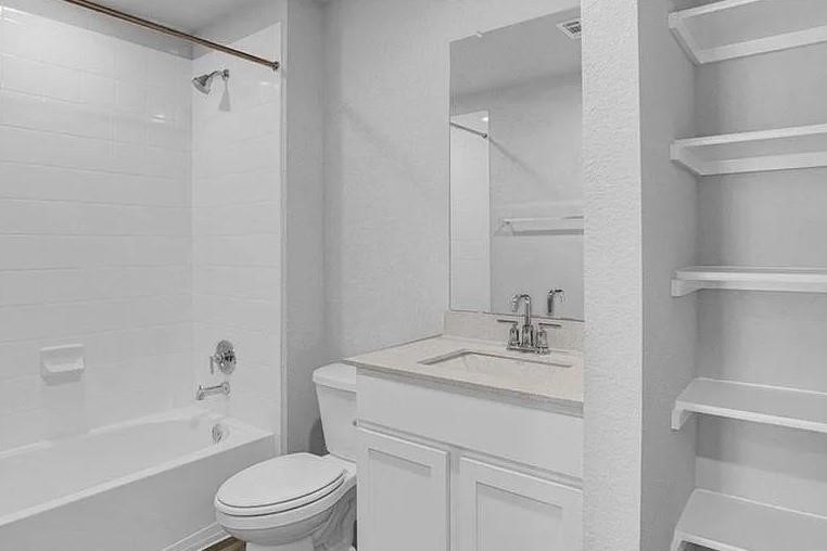 211 Hamilton Pool Lane Bastrop, TX 78602 - Photo 9 of 11 a bathroom with a sink a toilet and shower