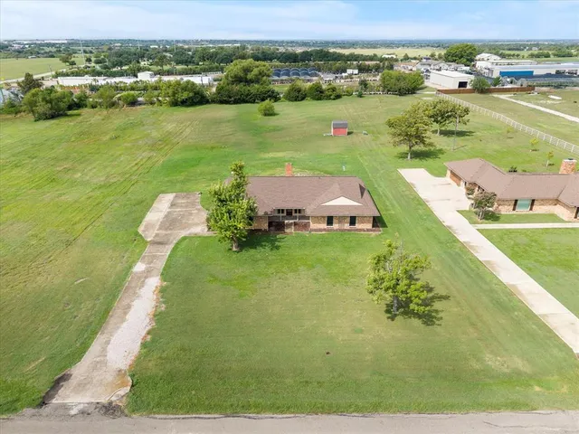 an aerial view of a house with a yard