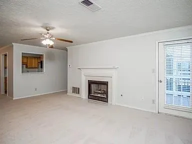 a view of empty room with a fireplace