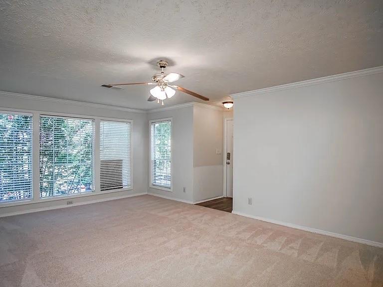 510 Berkeley Woods Drive Duluth, GA 30096 - Photo 5 of 8 an empty room with windows and chandelier fan