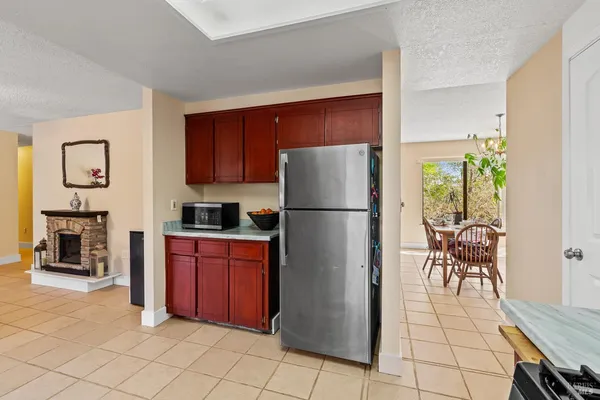 a kitchen with stainless steel appliances granite countertop a refrigerator and a stove top oven